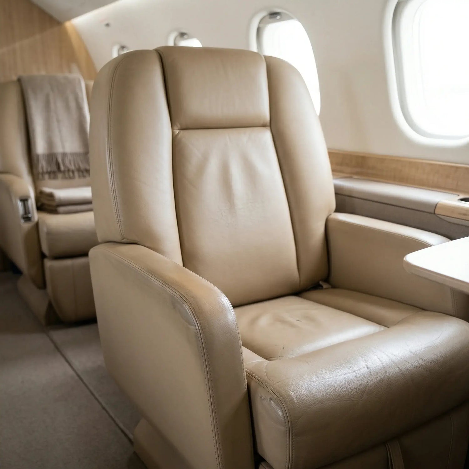 Beige leather airplane seat in a private jet cabin. Leather restoration for airplanes by Letech