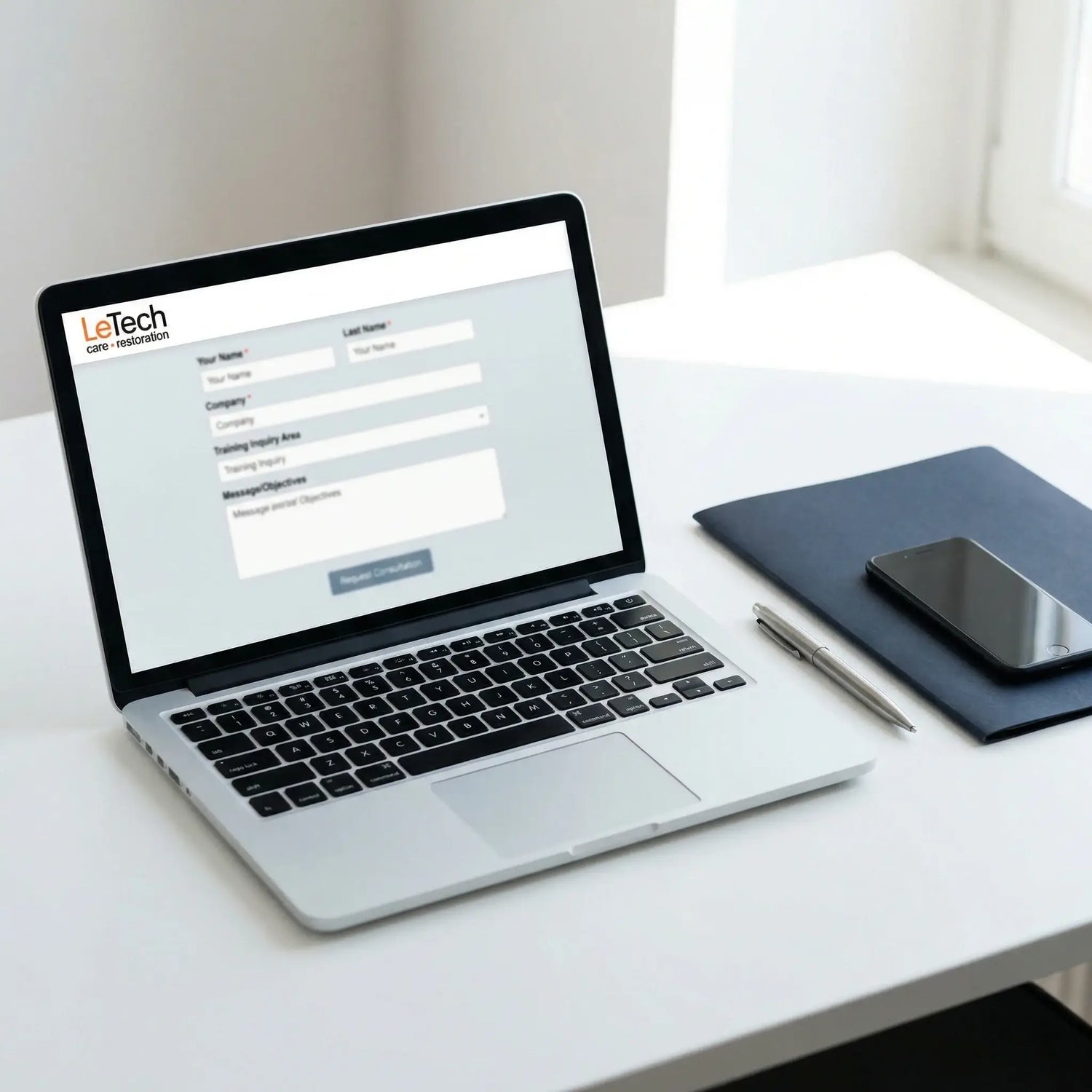 Laptop on a desk with a LeTech login screen displayed